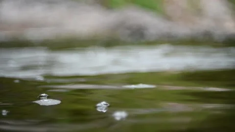 Waves and bubbles move in a pool of a mountain river (slow motion) Video stock 212755122