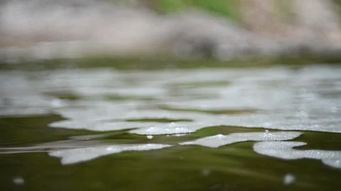Waves and bubbles move in a pool of a mountain river (slow motion, bokeh) Video stock 212755160