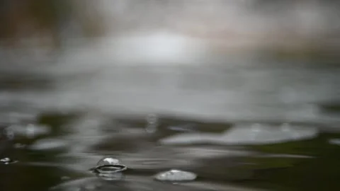 Waves and bubbles move in a pool of a mountain river (bokeh, slow motion) Video stock 212755264
