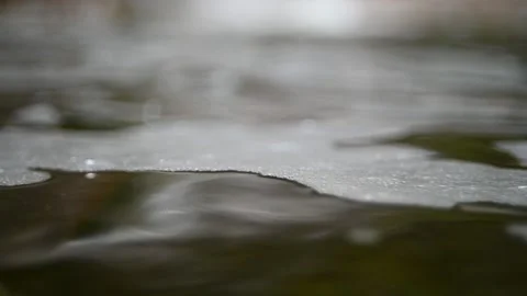 Waves and bubbles move in a pool of a mountain river (slow motion, bokeh) Video stock 212755791