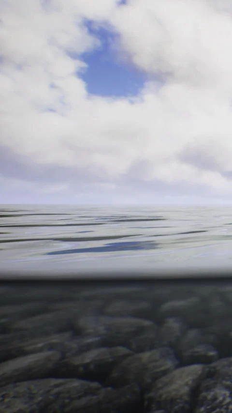 Waves and clouds interact over the surface of a body of water in a wide view Stock Footage 334259166