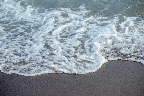 Waves and Foam on Sand Stock Photos