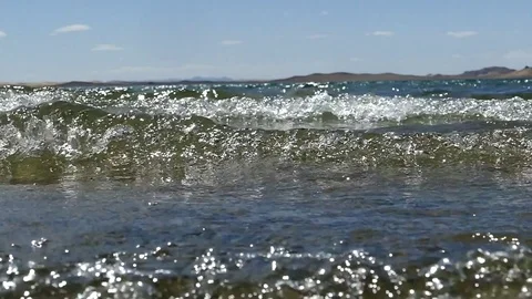 Waves and the  glare of the sun, slow motion. Stock-Footage 79130882