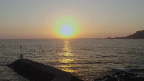 Waves and lighthouse sway in the sunset. Stock Footage 138692783