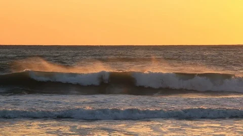 Waves and ocean mist at sunset Stock Footage 86387538