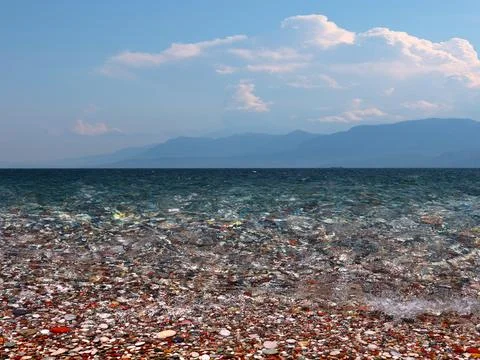 Waves and a pebble beach Stock Photos