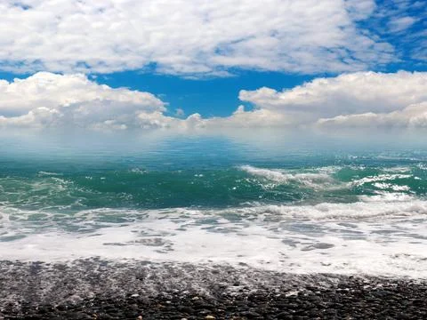 Waves and a pebble beach Stock Photos