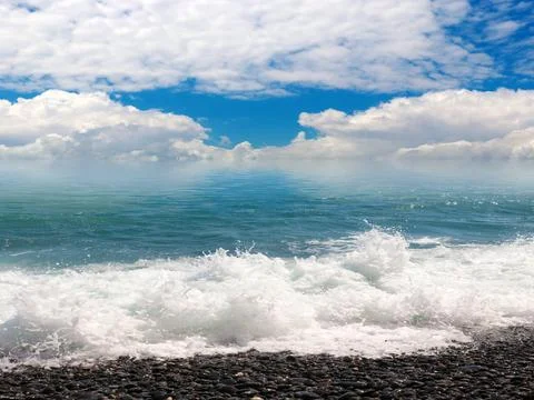 Waves and a pebble beach Stock Photos