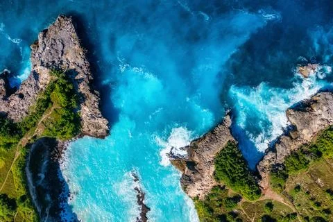 Waves and rocks as a background from top view. Blue water background from top Stock Photos
