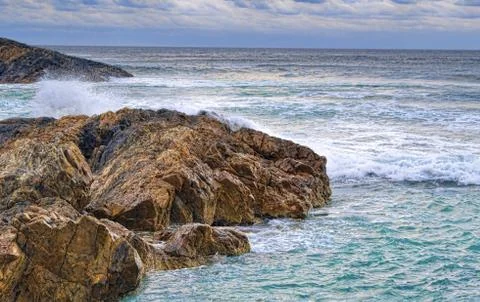 Waves and rocks on the coast Stock Photos
