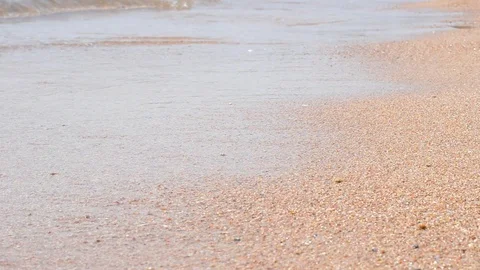 Waves and the sand on the beach close up 動画素材 99832955