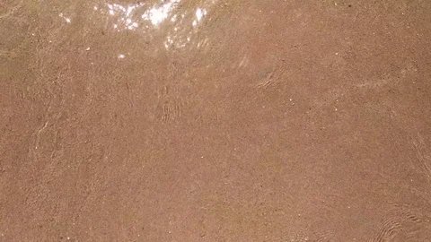 Waves and the sand on the beach close up Stock-Footage 99834166