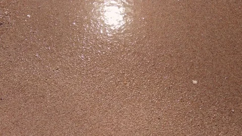 Waves and the sand on the beach close up Stock-Footage 99834215