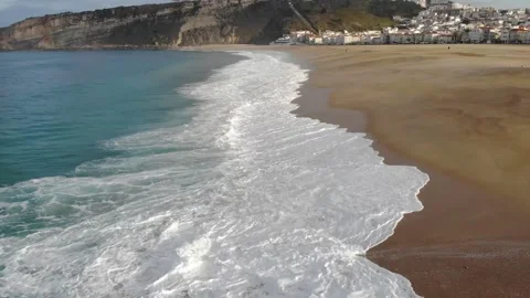 Waves and sand on Nazare beach Stock Footage 232093699