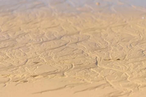 Waves and sand patterns at Albufeira beach Stock Photos