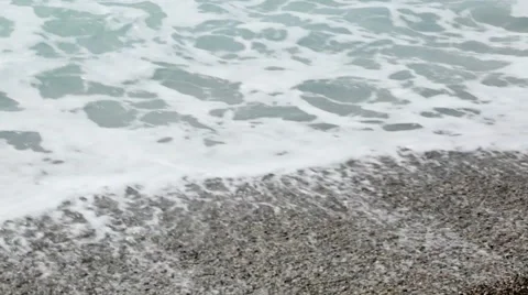 The waves and the sand on the stone beach, close up Stock Footage 61566543