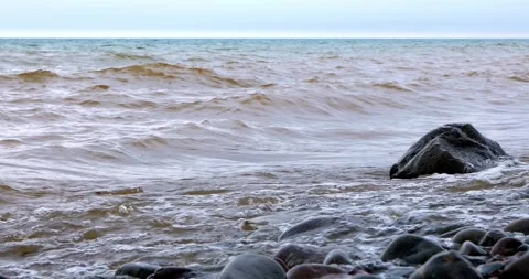 Waves and Splashes on rocks at shore of Lake Superior in Minnesota Video stock 283234481