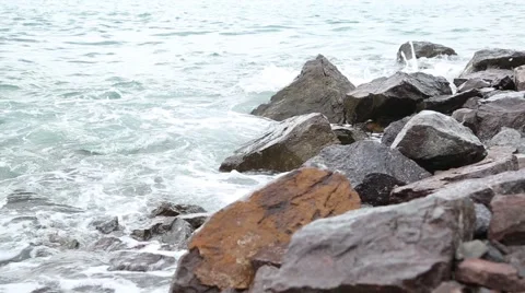Waves and stones on the beach Stock Footage 65376343