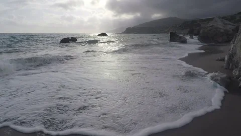 Waves and sun reflect in an Exotic Beach Stock Footage 75887406