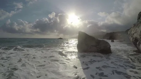 Waves and sun reflect in an Exotic Beach Stock Footage 75950709