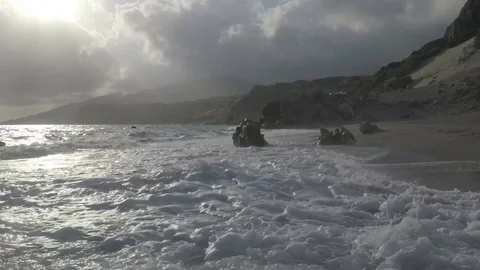 Waves and sun reflect in an Exotic Beach Stock Footage 75952886