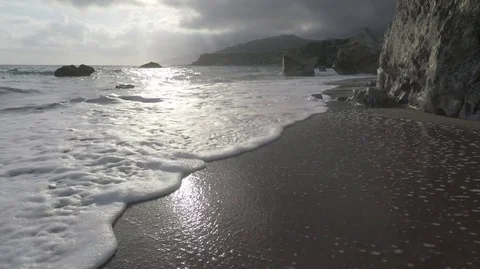 Waves and sun reflect in an Exotic Beach Stock Footage 75956162