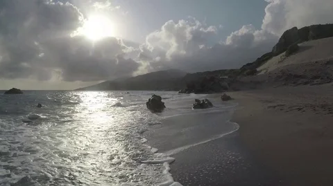 Waves and sun reflect in an Exotic Beach Stock Footage 75956974