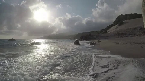 Waves and Sun reflect in an Exotic Beach Stock Footage 75958408