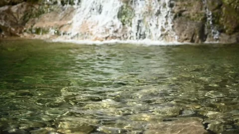 Waves and sunlight effects in the pool from a waterfall (slow motion, bokeh) Stock-Footage 219645188