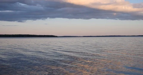Waves and sunset over the lake Video stock 129854308