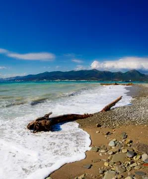 Waves and surf on the beach.  Pebble beach in the resort of Kabardinka, Krasn Stock Photos