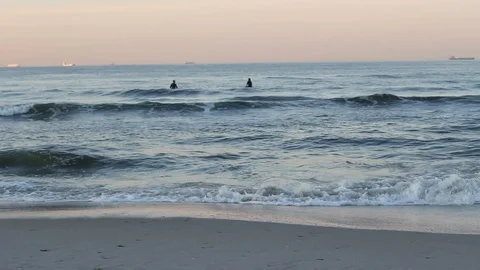 Waves and Surfers in the water Stock Footage 97723969