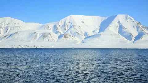 The waves of the Arctic Ocean and the snow-capped mountains of the Spitsbergen. Stock Footage 55071339