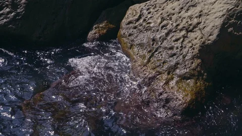 The waves are about big rocks on the ocean Stock Footage 103408116