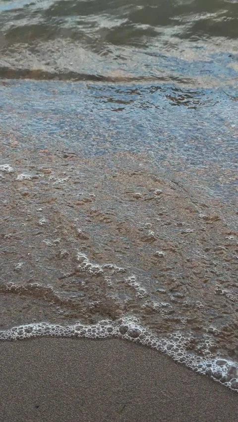 The waves are beating against the sandy shore Video stock 295488915