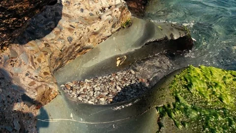 Waves are beating a big stone on the shore. Slow motion. Stock Footage 95550643