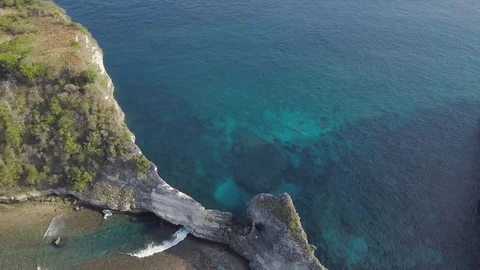 Waves are coming underneath of the rock aerial footage of Indonesia Stock Footage 101984728