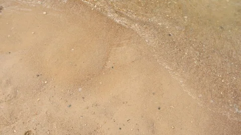 Waves are floating on the sandy beach 4K close-up Stock Footage 98952213