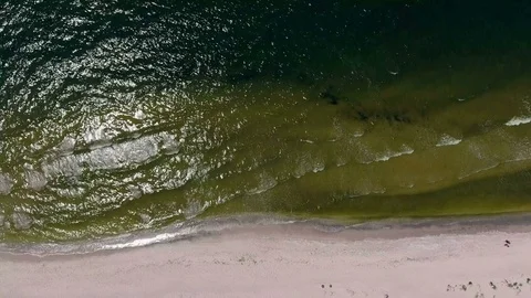 Waves are gently washing up the beach sand, Video stock 82217738
