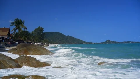 Waves are rolling on the rocks on the beach. The coast of a tropical beach.  Stock Footage 127902892