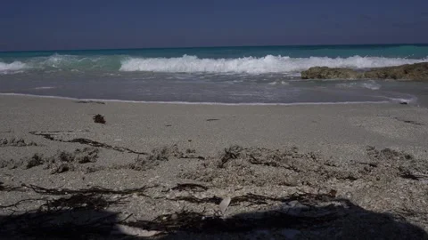 The waves are so close with a cluster of rocks to the right Stock Footage 305132681