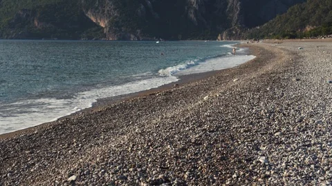 The waves are washing the beach with sand and pebbles on the shores of the Stock Footage 101710160