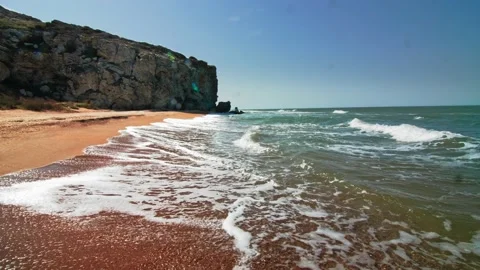 The waves are wetting the sand on the sea beach, view from the side In the Stock Footage 220633190
