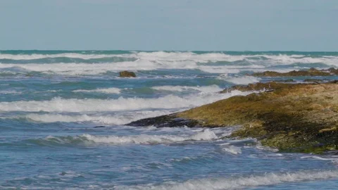 Waves area going to the coastal rocks in Italy Stock Footage 90063737