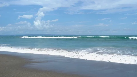 Waves arrive on shore at a beach in Bali Video stock 74288420