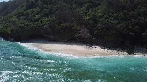 Waves Arriving on Small Secluded Beach [Drone Footage] Stock Footage 96236932