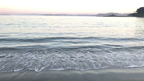 Waves arriving softly at the edge of the beach on a beautiful autumn sunset 動画素材 143851914