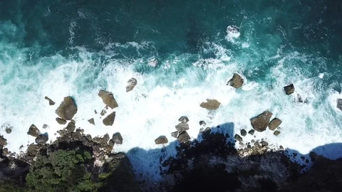 Waves Arriving on Steep Cliffs From Above [Drone Footage] Stock Footage 96236171