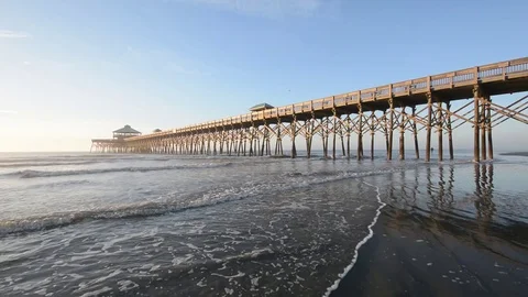 Waves in the Atlantic Ocean and the pier, at Folly Beach, near Charleston, South Stock Footage 71634922