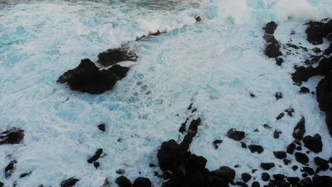 Waves of the Atlantic ocean beat against the rocky shore, black volcanic sand Video stock 102303954